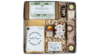 A gift box by Indigenous box including various soaps, lip balm, and bath salts for rejuvenation. 